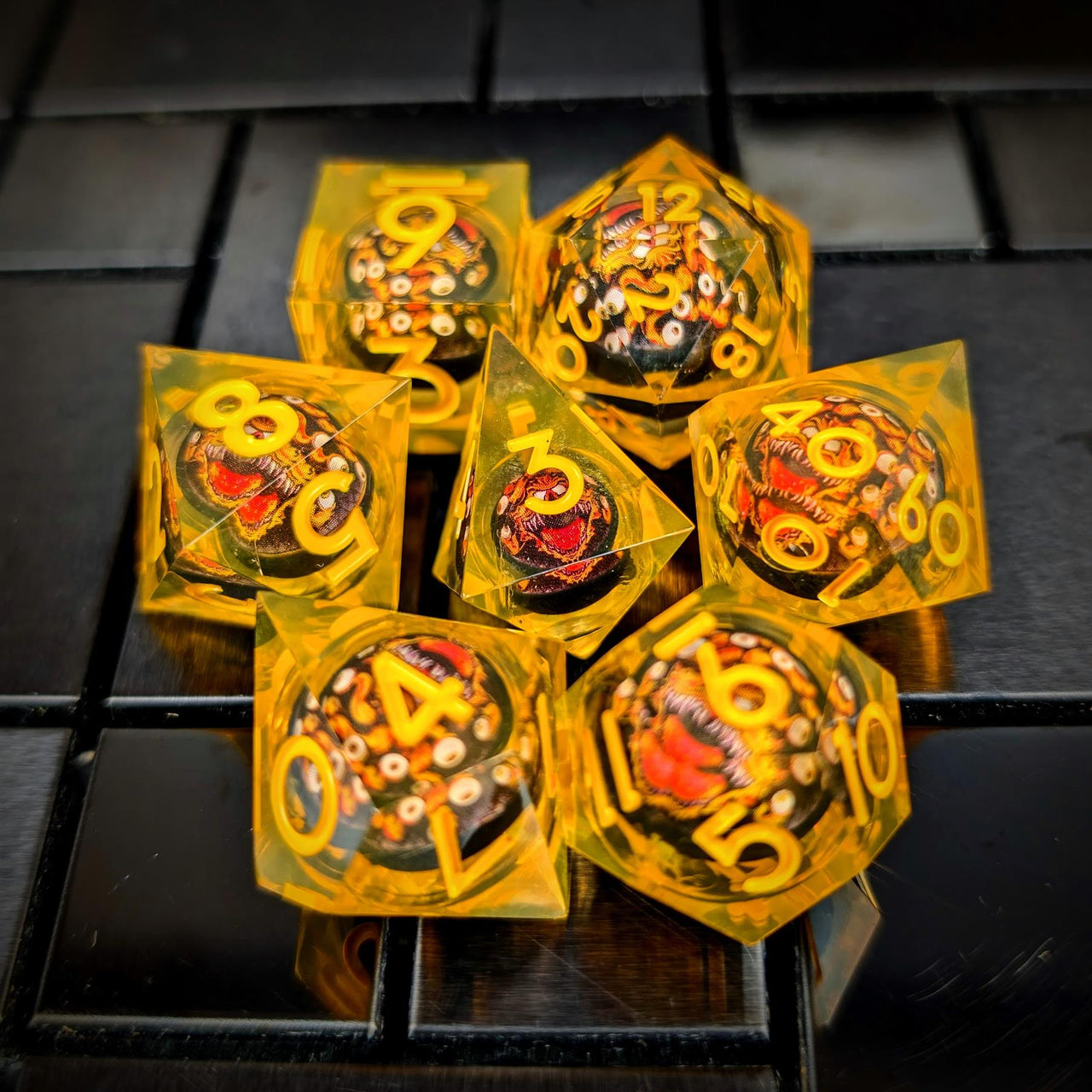 Orange Beholder in Orange & Clear Liquid Filled Sharp Resin - 7pcs RPG Dice Set