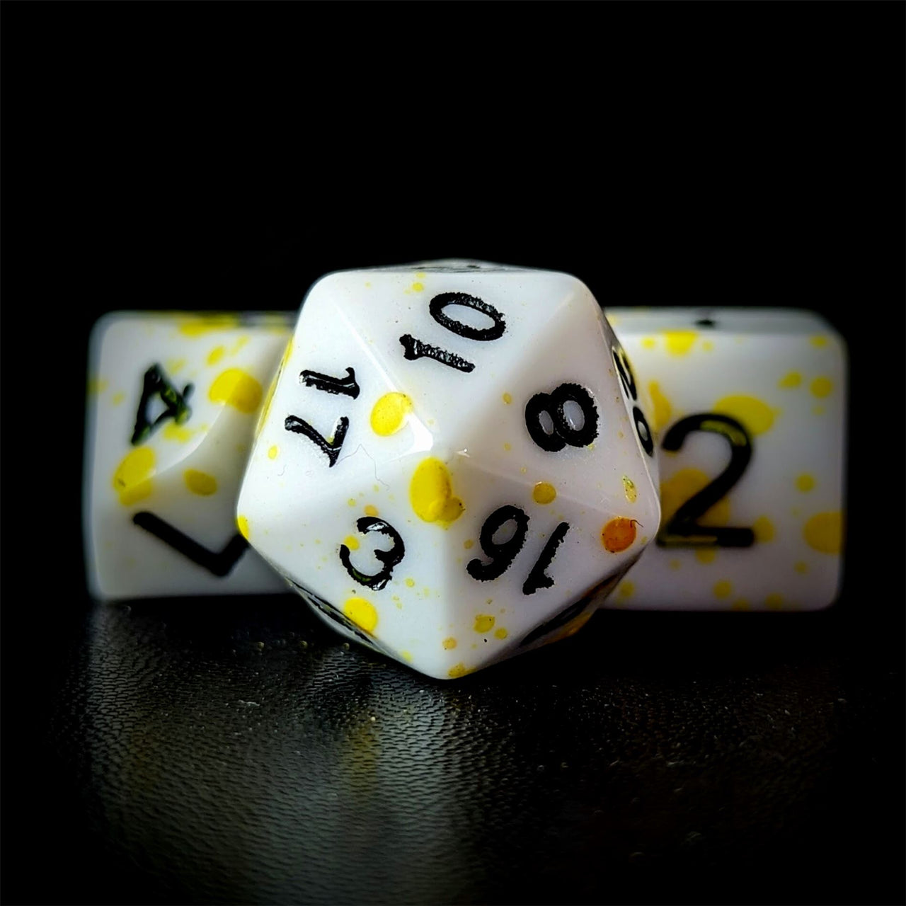 Yellow Blood Splatter on White Acrylic - 7pcs RPG Full Dice Set Close