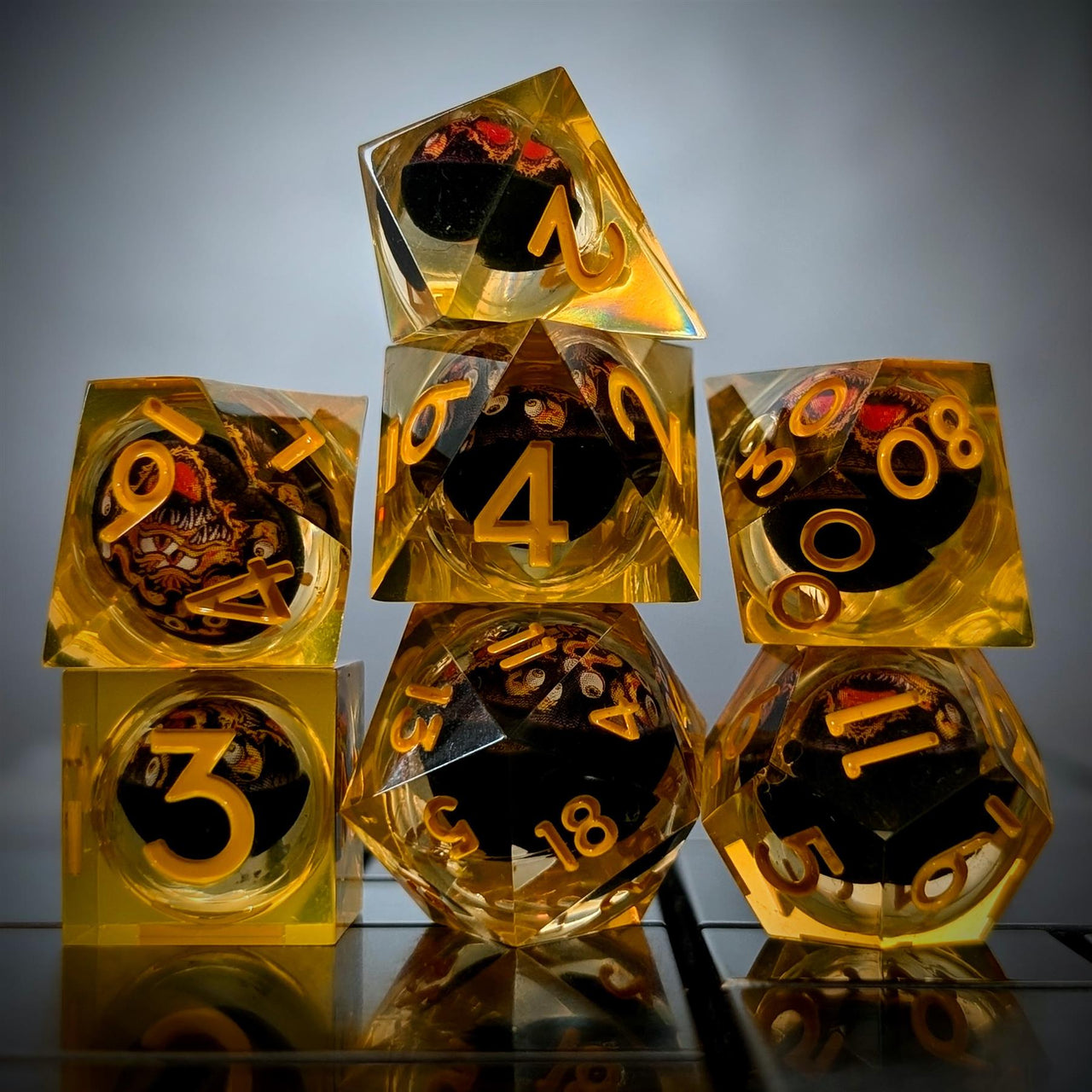 Orange Beholder in Orange & Clear Liquid Filled Sharp Resin - 7pcs RPG Dice Set