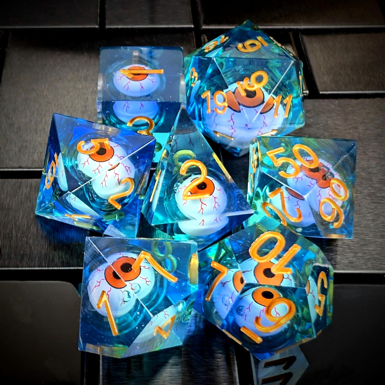 Orange Eye Ball in Clear & Blue Liquid Filled Sharp Resin - 7pcs RPG Dice Set